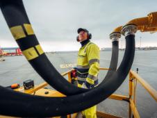 An Airport Worker watches as a plan is fueled up